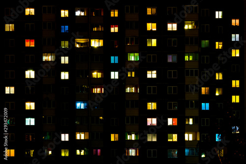 Cuadro en lienzo Flat night panorama of multicolor light in windows of multistory buildings