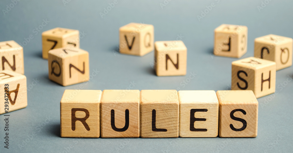 Wooden blocks with the word Rules. Setting rules, laws. Legislation. Religious and folk traditions. Wooden blocks with the word Rules. Setting rules, laws. Legislation. Religious and folk traditions.