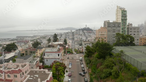 Aerial panoramic view of Lombard Street, an east–west street in San Francisco, CA. Famous for steep, one-block section with eight hairpin turns. Crookedest, steep hills, sharp curves, one-way road.