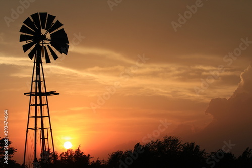 Kansas Windmill at Sunset with the Sun and clouds