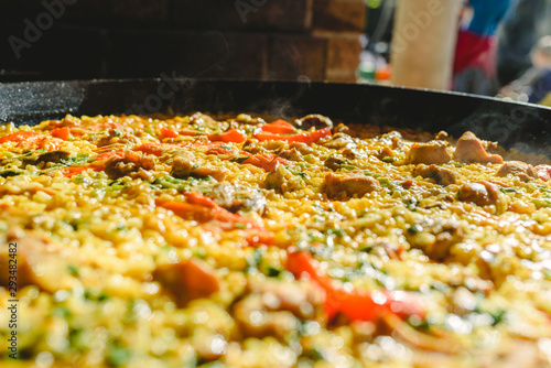 Fototapeta Naklejka Na Ścianę i Meble -  Rice and rabbit, typical dish of the gastronomy of the region of Murcia, Spain, cooked in a paella pan.