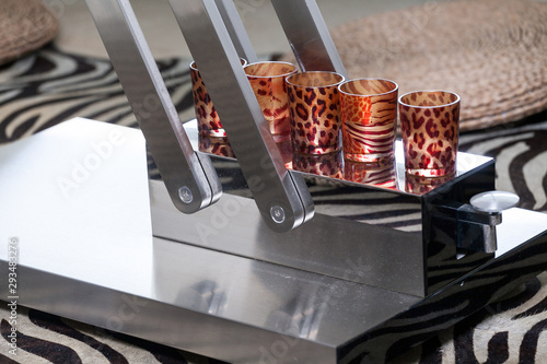 Home decoration, modern steel table with stamped glass cups.