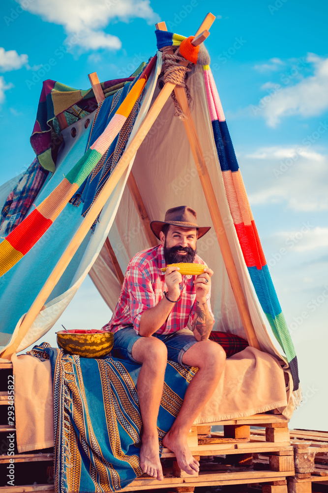 Obraz premium Love makes a cottage a castle. Cozy play tent for man on nature over sky background - isolated. Morning landscape with tent on sky background.