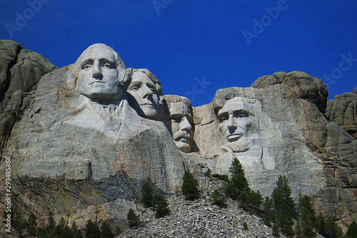 View of Mt. Rushmore in the Black Hills of South Dakota with a dark blue sky.
