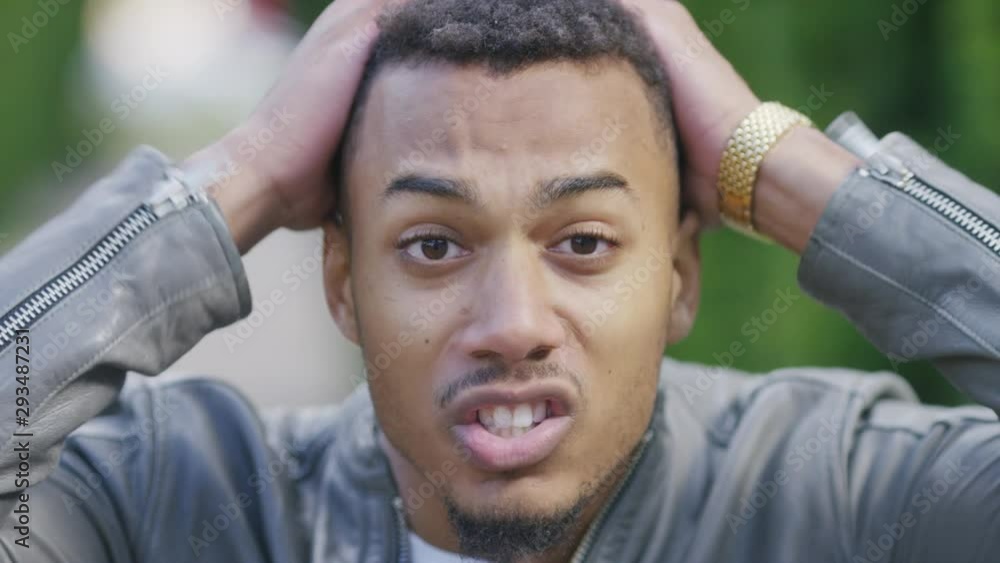 Handsome black male reacts to camera after hearing some news, in slow motion Handsome black male reacts to camera after hearing some news, in slow motion