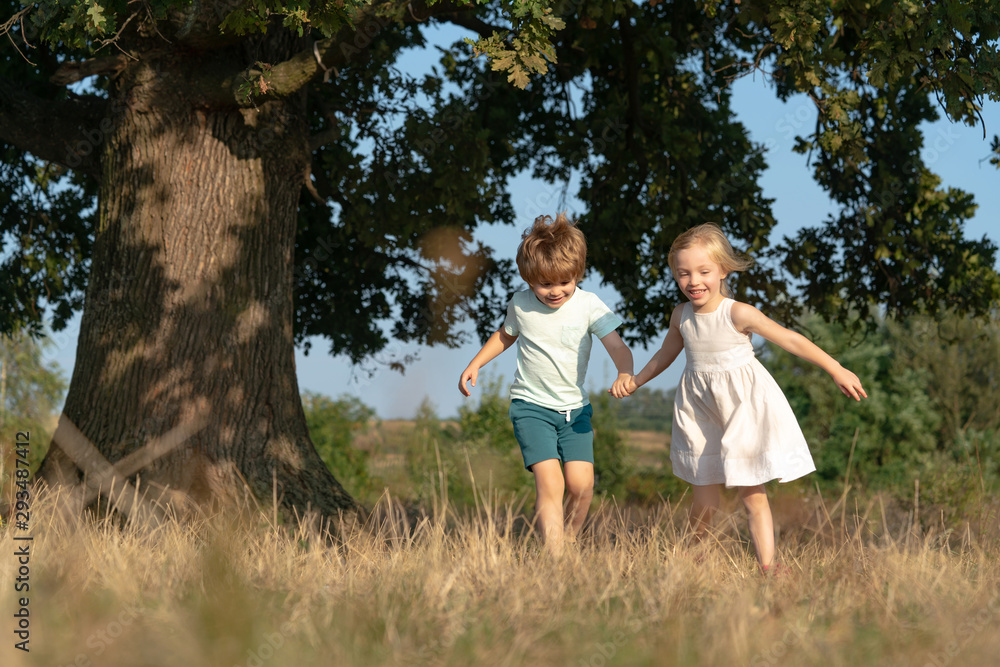 Children run on field. Children farmer concept. Happy children farmers working with spud on spring field. Happy children farmers having fun on spring field. Ecology concept child.