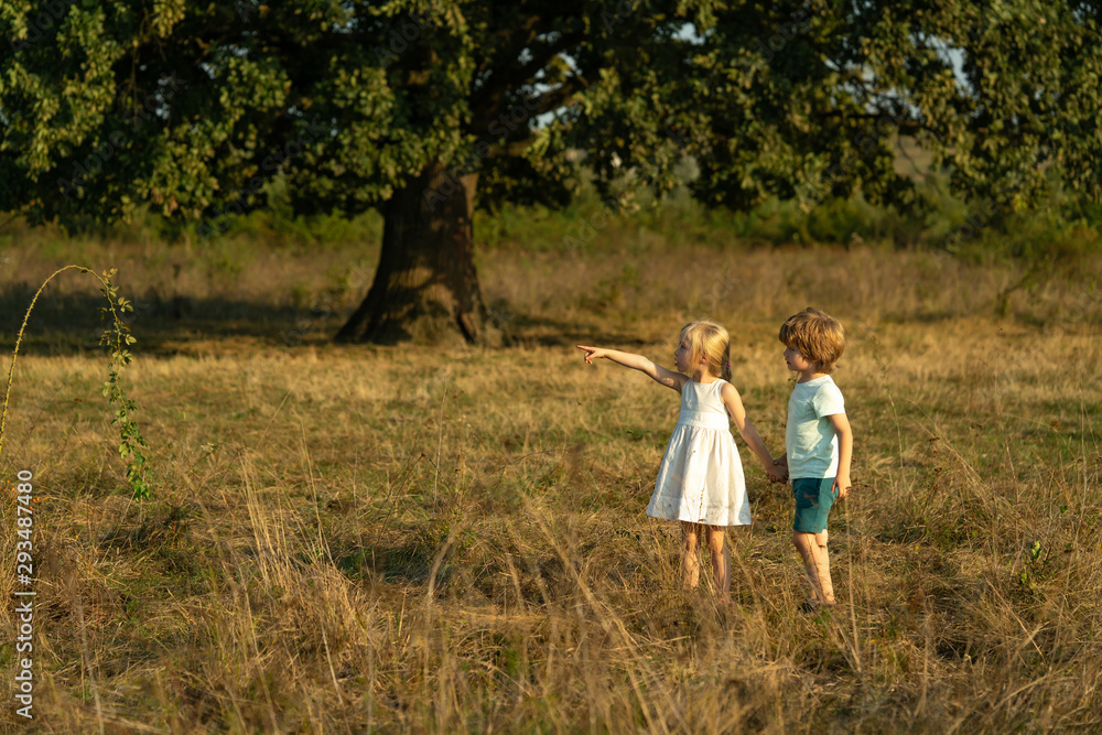 Earth day. Little family farmers. Eco farm for kids. Children farmer in the farm with countryside background. Springtime on the ranch. Toddler age. Eco farm workers. Earth day. Little family farmers. Eco farm for kids. Children farmer in the farm with countryside background. Springtime on the ranch. Toddler age. Eco farm workers.