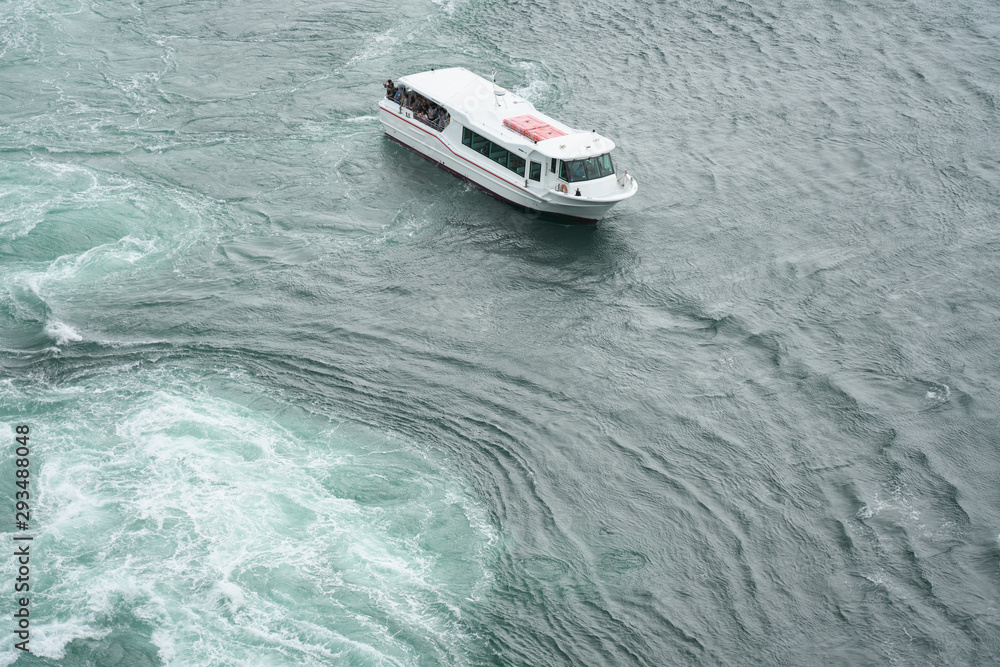 Naruto,Japan-September 28, 2019: The world largest whirlpools in Naruto Channel and a sightseeing boat