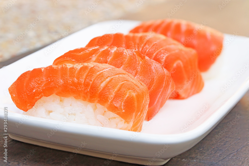 Close up of fresh japanese salmon sushi in white dish..