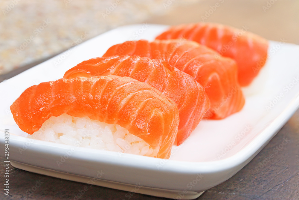 Close up of fresh japanese salmon sushi in white dish.. Close up of fresh japanese salmon sushi in white dish..