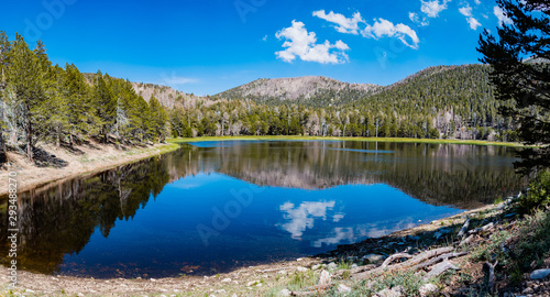 Remote mountain lake reflecting blue summer sky
