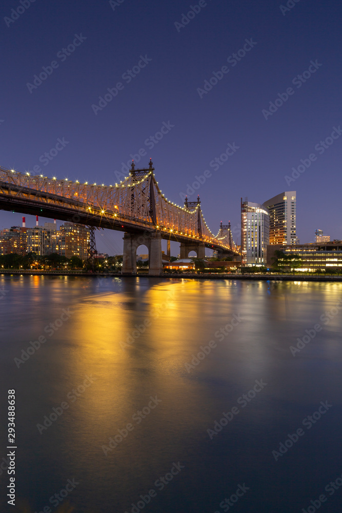View on Queensboro Bridge and Roosevelt island architecture at night with long exposure
