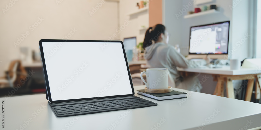 Blank screen tablet with keyboard on white wooden table with office supplies Blank screen tablet with keyboard on white wooden table with office supplies