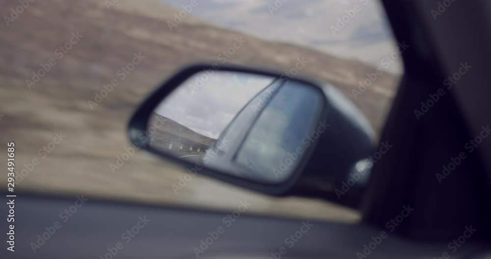4K Side view Mirror on a Car Travelling through The Glen Coe Scottish Mountains. Traffic travelling within a remote rural Tourist destination in Scotland. 4K Side view Mirror on a Car Travelling through The Glen Coe Scottish Mountains. Traffic travelling within a remote rural Tourist destination in Scotland.