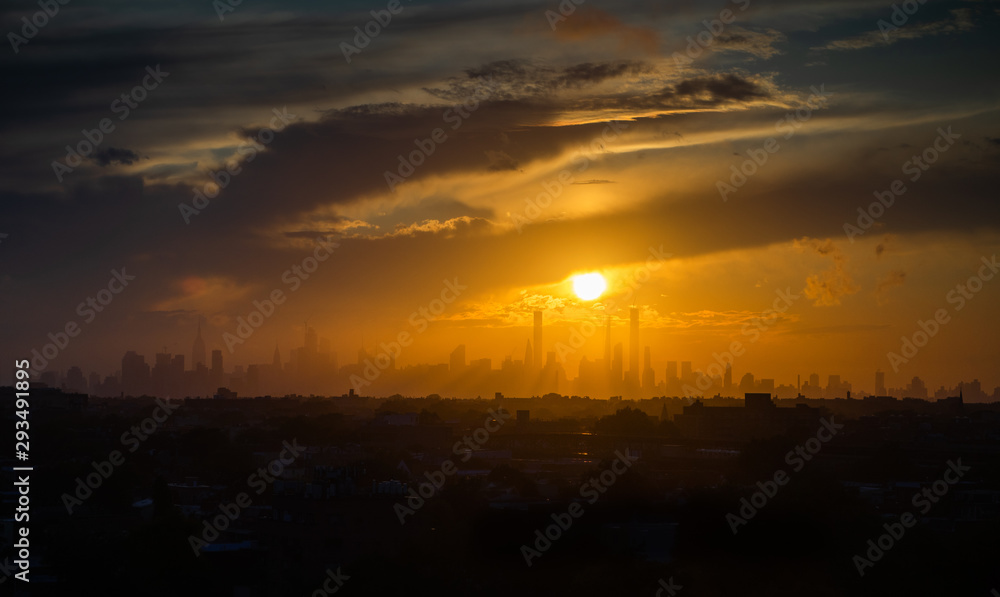 the skyline of new york during sunset with some silhouettes of skyscrapers