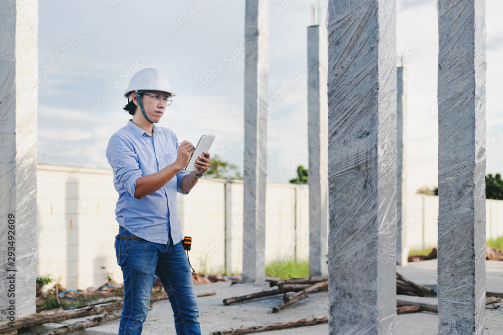 Male architect, inspecting house construction