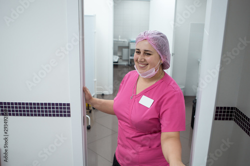 Attractive nurse in hospital smiling at new patient
