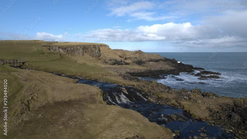 Waterfall and headland at Dunseverick Castle, Co Antrim, Northern Ireland Waterfall and headland at Dunseverick Castle, Co Antrim, Northern Ireland