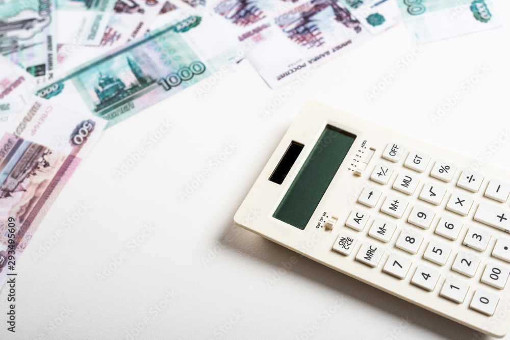 selective focus of calculator near russian money on white selective focus of calculator near russian money on white
