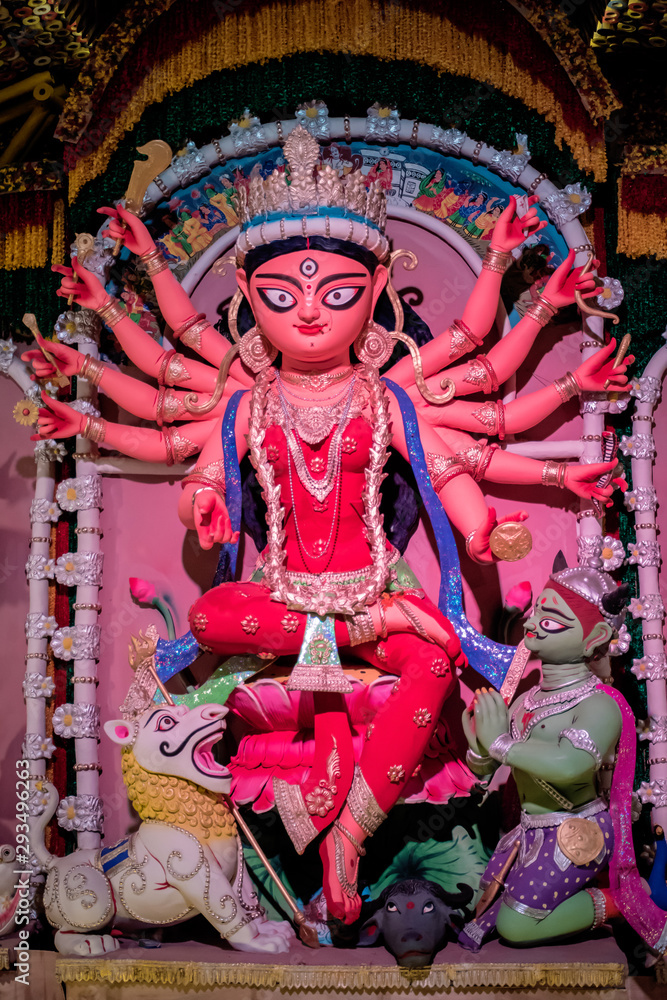 Fototapeta premium Idol of Goddess Devi Durga at a decorated puja pandal in Kolkata, West Bengal, India. Durga Puja is a popular and major religious festival of Hinduism that is celebrated throughout the world.