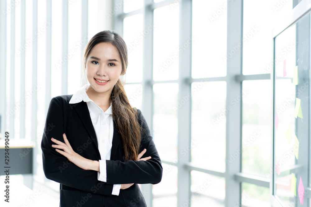 Portrait of beautiful and smart Asian businesswoman in formal suit standing beside window close up. Modern lifestyle and professional people concept. Portrait of beautiful and smart Asian businesswoman in formal suit standing beside window close up. Modern lifestyle and professional people concept.