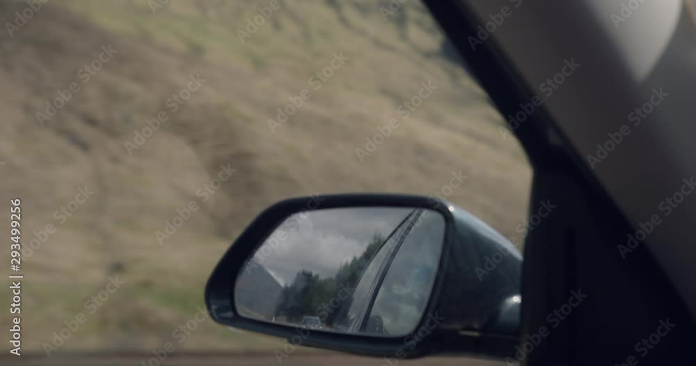 4K Passenger Side view Mirror in The Glen Coe Scottish Mountains. Car travelling through Tourist Mountain Range within a Natural holiday destination in rural Scotland. 4K Passenger Side view Mirror in The Glen Coe Scottish Mountains. Car travelling through Tourist Mountain Range within a Natural holiday destination in rural Scotland.