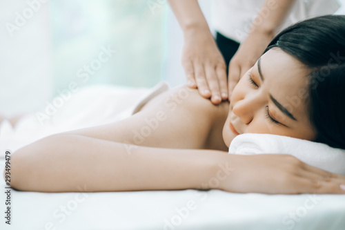 Beautiful young woman lying down on beds massage and spa at asian spa massage and beauty salon center, spa concept, massage concept