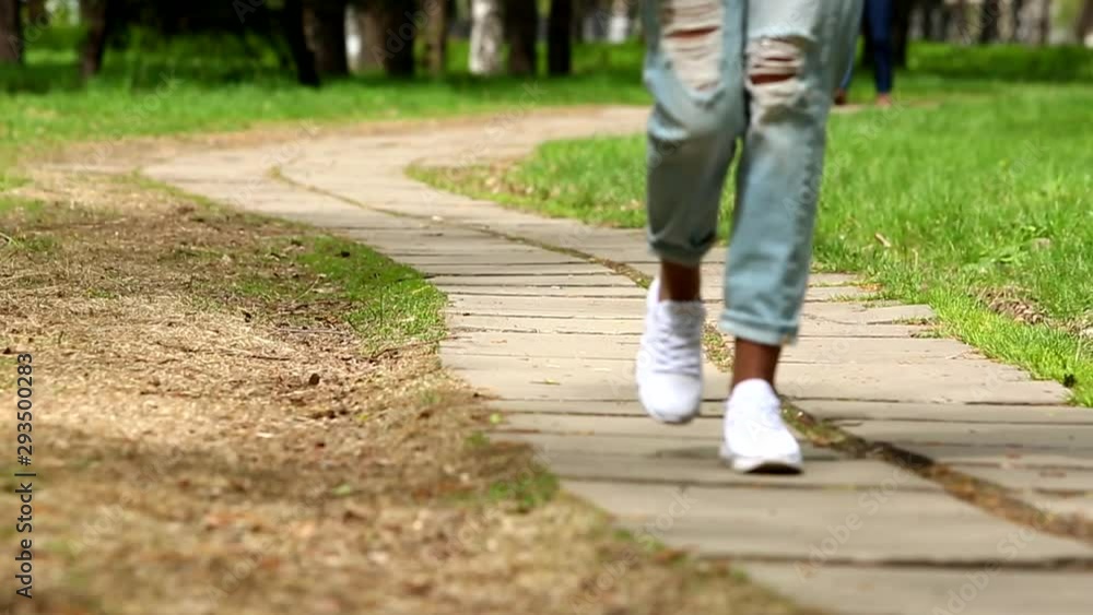 video close-up female legs walk in the park video close-up female legs walk in the park