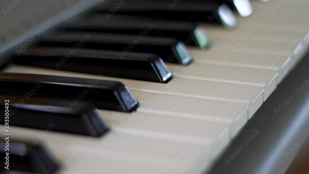A close up from a high angle of a keyboard piano. A close up from a high angle of a keyboard piano.