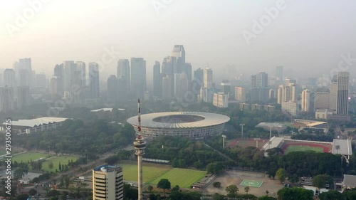 Aerial view of Gelora Bung Karno Main Stadium in Senayan in Jakarta City, showing SCBD complex in BackGround. Dolly move with TVRI Tower