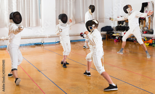 Group practicing fencing techniques