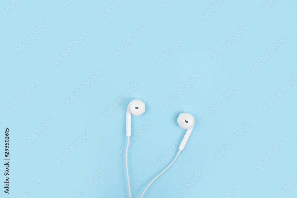 Earphone on a blue background. Close up. Earphone on a blue background. Close up.