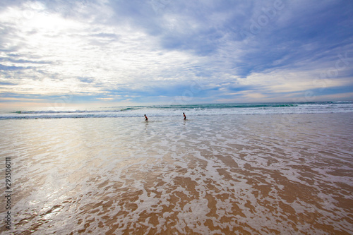 boys running on the beach