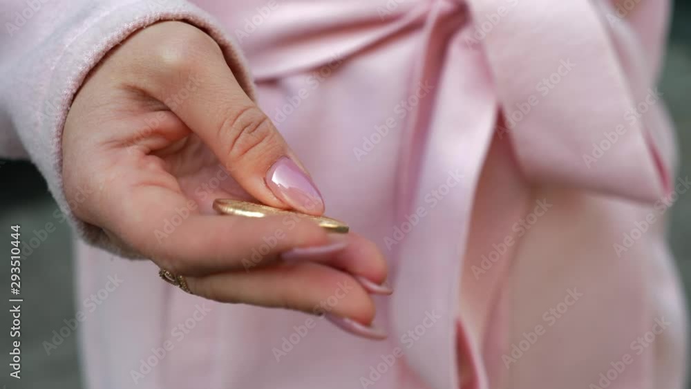 Young attractive woman in pink coat is shopping for cryptocurrency. Close-up view of lady in the street who holds gold coin of Bitcoin. Christmas holidays, sale and retail industry concept. 4K footage Young attractive woman in pink coat is shopping for cryptocurrency. Close-up view of lady in the street who holds gold coin of Bitcoin. Christmas holidays, sale and retail industry concept. 4K footage