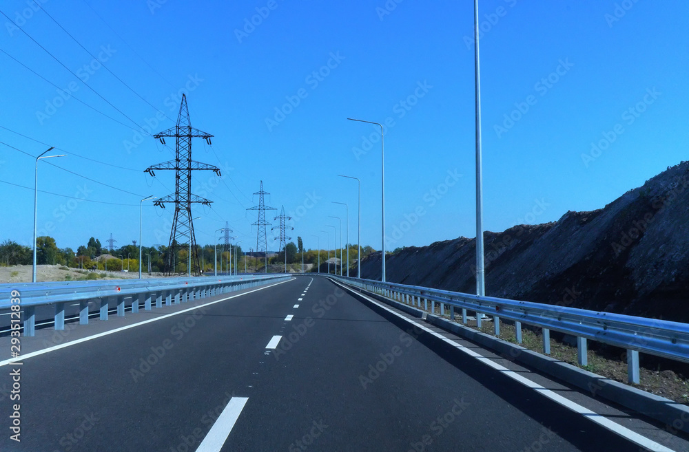 Fototapeta premium Landscape with rocks, sunny sky with clouds and beautiful asphalt road