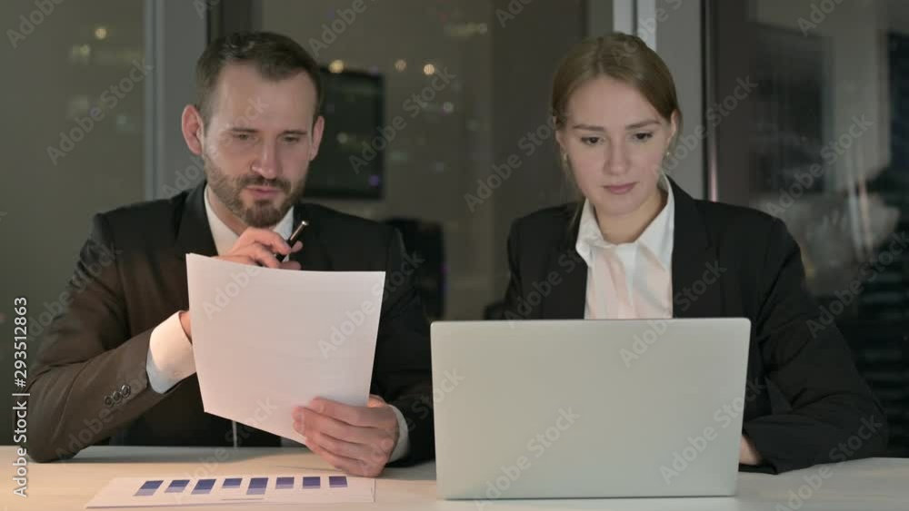 Executive Business people Working on Documents and Laptop at Night Executive Business people Working on Documents and Laptop at Night