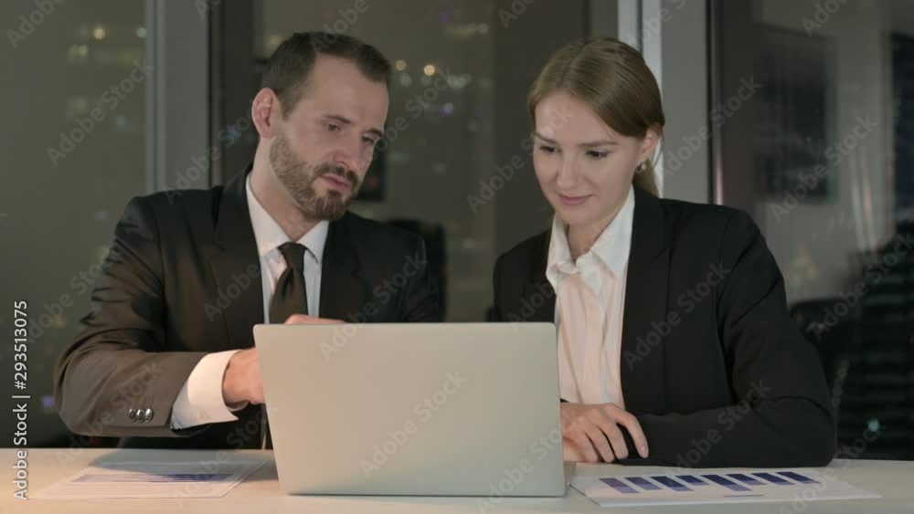 Executive Business people Reading report on Laptop at Night Executive Business people Reading report on Laptop at Night