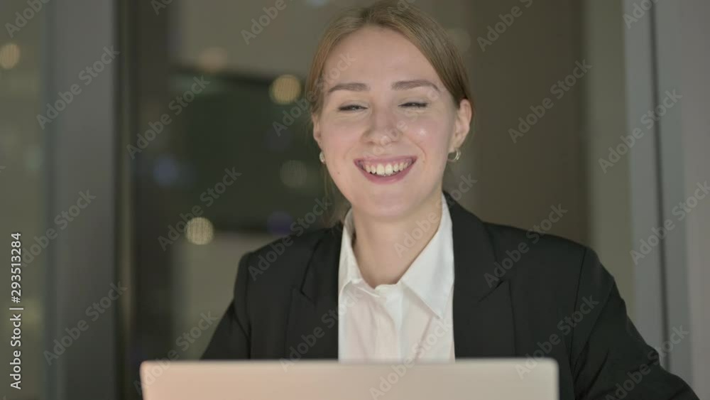 Close Up of Cheerful Businesswoman Smiling in Office at Night Close Up of Cheerful Businesswoman Smiling in Office at Night