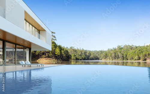 Perspective of luxury modern house with swimming pool in day time on forest lake background, Idea of minimal architecture design. 3D rendering