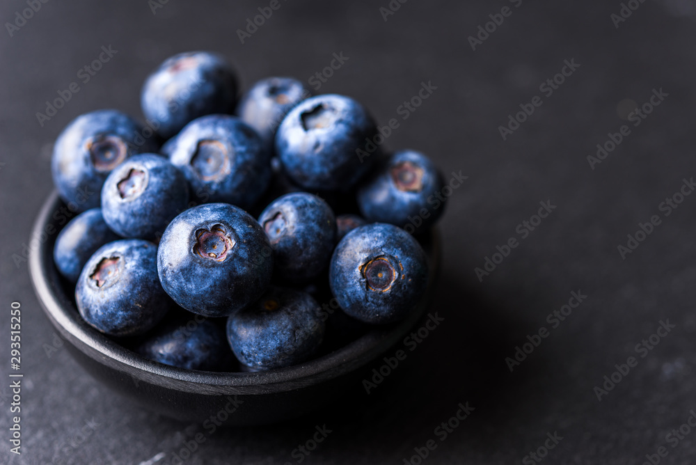 Close up of fresh organic blueberries on black background Close up of fresh organic blueberries on black background