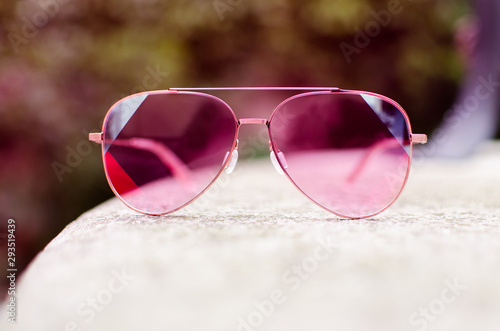 Pink sunglasses with pink lenses isolated outdoor