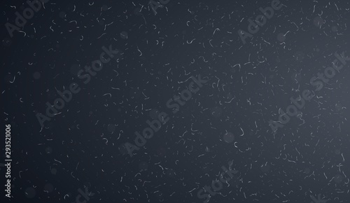 Macro dust particles flying over dark background. Abstract white dust particles in the air. Abstract dust overlay texture.