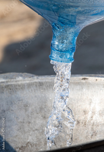 Water is poured from the canister for cooking. © Prikhodko