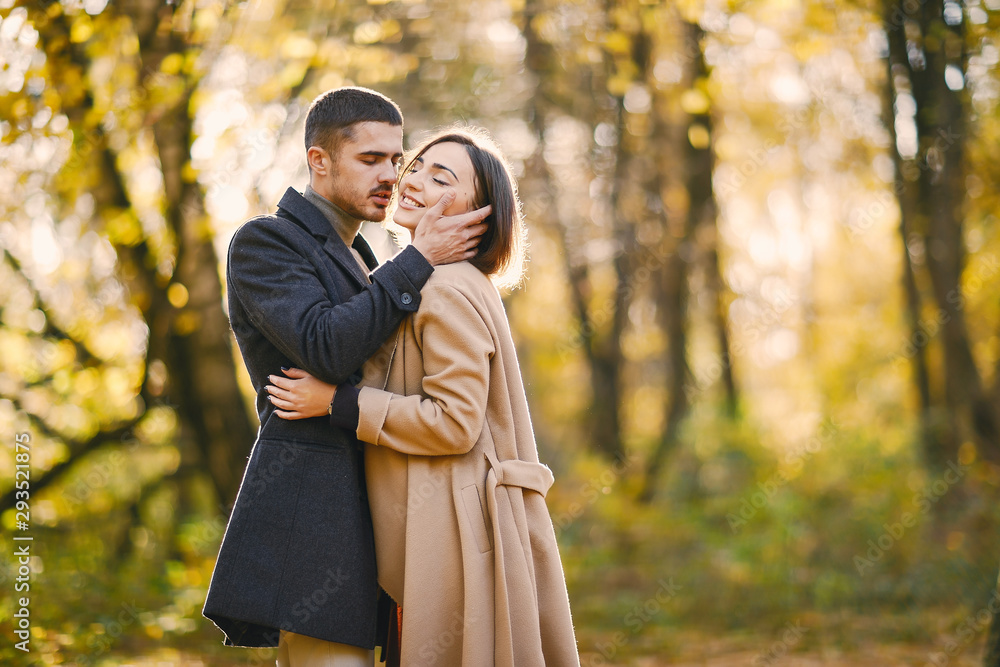lovely couple walking around the park during autumn lovely couple walking around the park during autumn