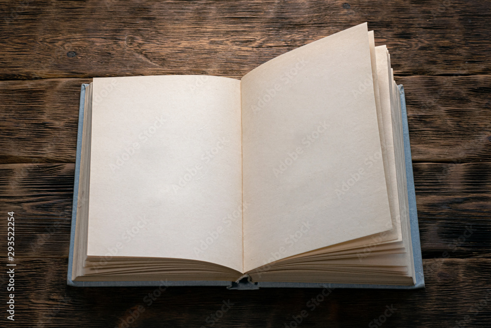 Fototapeta premium Open blank page book on brown background.