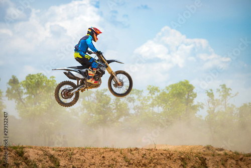 Fototapeta Naklejka Na Ścianę i Meble -  Motocross Rider Jump in a blue sky with clouds.Enduro bike rider in action. 