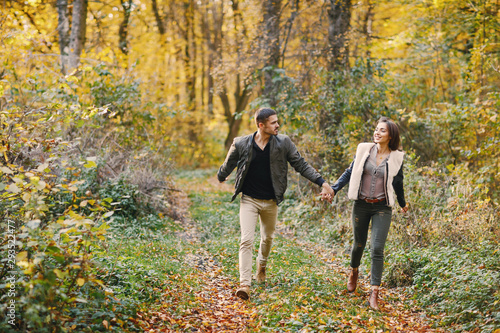 lovely couple walking around the park during autumn © prostooleh