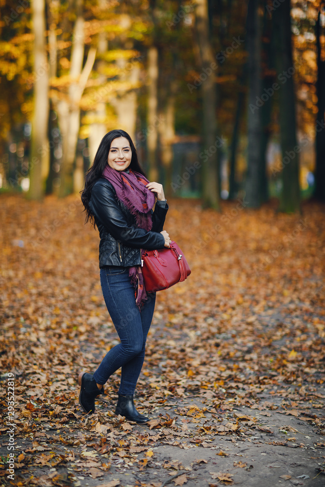 brunette girl relaxing at the park during autumn brunette girl relaxing at the park during autumn
