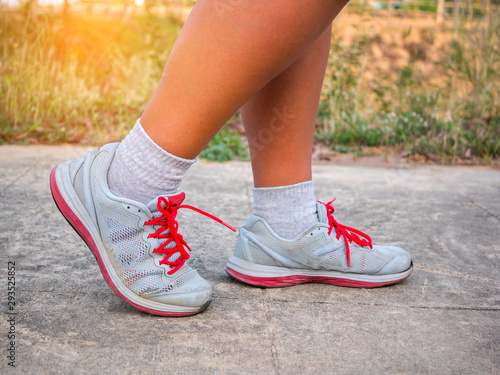 Running sport. Man runner legs and shoes in action on road.