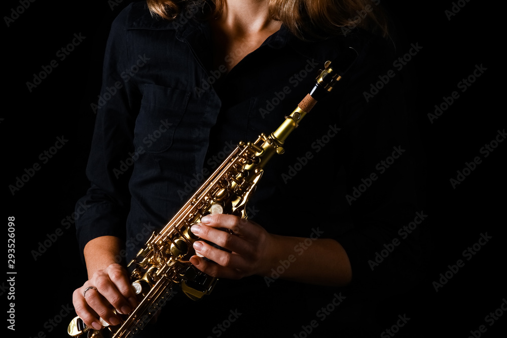 Fototapeta premium soprano saxophone in hands on a black background